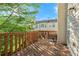 Outdoor deck with wood railings and a view of the lawn and neighboring houses at 745 Abbotts Mill Ct, Johns Creek, GA 30097