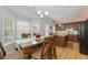 Dining area features hardwood floors, large windows, and adjoins the eat-in kitchen at 745 Abbotts Mill Ct, Johns Creek, GA 30097