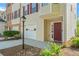 Charming front entry with a brick accent, a well-manicured lawn and red door at 745 Abbotts Mill Ct, Johns Creek, GA 30097