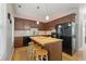 Eat-in kitchen with dark cabinets, a wood island, and modern appliances at 745 Abbotts Mill Ct, Johns Creek, GA 30097
