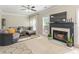 Open-concept living room with a fireplace, plush seating, and neutral colors at 745 Abbotts Mill Ct, Johns Creek, GA 30097
