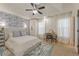 Spacious main bedroom with designer wallpaper, ceiling fan, and light-filled windows at 745 Abbotts Mill Ct, Johns Creek, GA 30097