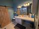 This bathroom has a sliding wood door and vanity at 1235 Jasmine Green Ct, Dacula, GA 30019