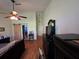 This bedroom features a ceiling fan, TV, and barn door to the bathroom at 1235 Jasmine Green Ct, Dacula, GA 30019