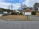Charming single-story home featuring brick accents, manicured landscaping, and an attached two-car garage at 1235 Jasmine Green Ct, Dacula, GA 30019