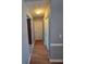 Hallway featuring neutral paint colors, wood floors, and access to other rooms in the house at 1235 Jasmine Green Ct, Dacula, GA 30019