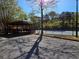 Community tennis court and covered pavilion are surrounded by mature trees at 1235 Jasmine Green Ct, Dacula, GA 30019