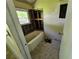 Bathroom under construction featuring an old tub, window and exposed framing at 1846 Markone Nw St, Atlanta, GA 30318