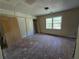 Bedroom featuring window, closet, and worn wood floors, ready to customize at 1846 Markone Nw St, Atlanta, GA 30318