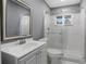 Modern bathroom with white vanity, marble-style shower, and sleek glass door at 2681 Tilson Rd, Decatur, GA 30032