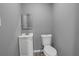 Modern bathroom with white vanity, framed mirror, and sleek toilet at 2681 Tilson Rd, Decatur, GA 30032