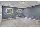 Cozy bedroom featuring neutral carpeting and natural light from two windows at 2681 Tilson Rd, Decatur, GA 30032