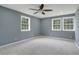 Bright bedroom featuring neutral carpeting and natural light from three windows at 2681 Tilson Rd, Decatur, GA 30032