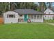 Charming home featuring a teal front door, inviting porch, and a well-manicured lawn at 2681 Tilson Rd, Decatur, GA 30032