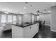 Open-concept living room features a kitchen island, modern lighting, and hardwood floors at 2681 Tilson Rd, Decatur, GA 30032