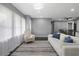 Bright living room featuring a comfortable couch, modern lighting, and an open floorplan at 2681 Tilson Rd, Decatur, GA 30032