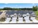 Aerial view of newly constructed townhomes with black roofs, garages, and paved driveways at 290 Silver Moon Drive # 111, Loganville, GA 30052