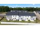 Aerial view of newly constructed townhomes with black roofs and green backyards and landscaping at 290 Silver Moon Drive # 111, Loganville, GA 30052