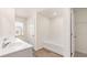 Bathroom featuring double sinks, a bathtub, tiled floors, and a separate doorway to closet at 290 Silver Moon Drive # 111, Loganville, GA 30052