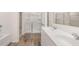 Bathroom featuring a glass enclosed shower, double sinks, vanity with white cabinets and tile floors at 290 Silver Moon Drive # 111, Loganville, GA 30052