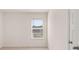 Bedroom with window showcasing the neighborhood outside, clean white walls, and neutral carpeting at 290 Silver Moon Drive # 111, Loganville, GA 30052