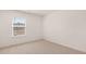 Bright and airy bedroom with neutral carpet, clean white walls, and a window overlooking a neighborhood at 290 Silver Moon Drive # 111, Loganville, GA 30052