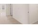 Hallway showcasing access to a room, neutral carpeting, and crisp white walls at 290 Silver Moon Drive # 111, Loganville, GA 30052