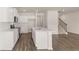 Open concept kitchen features an island and stainless steel appliances at 290 Silver Moon Drive # 111, Loganville, GA 30052