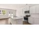 Bright kitchen features an island and stainless steel appliances at 290 Silver Moon Drive # 111, Loganville, GA 30052