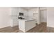 Bright kitchen features an island and stainless steel appliances at 290 Silver Moon Drive # 111, Loganville, GA 30052