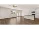 Open-concept living room with wood floors, a ceiling fan, and a modern kitchen with stainless steel appliances at 290 Silver Moon Drive # 111, Loganville, GA 30052