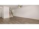 Bright living room with staircase, hardwood floors, and ceiling fan at 290 Silver Moon Drive # 111, Loganville, GA 30052
