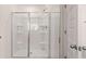 Modern bathroom features a white shower with a clear glass door and chrome hardware at 290 Silver Moon Drive # 111, Loganville, GA 30052