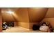 Spacious carpeted attic space with storage and a cozy nook featuring teddy bears and stuffed animals at 9390 Colonnade Trl, Johns Creek, GA 30022