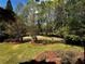Expansive backyard featuring lush landscaping, a fenced perimeter, and mature trees; perfect for outdoor enjoyment at 9390 Colonnade Trl, Johns Creek, GA 30022