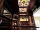 Close up of the basement bar featuring stained glass and custom carved features at 9390 Colonnade Trl, Johns Creek, GA 30022