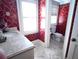 Half-bath with elegant patterned wallpaper, granite countertop, and bright natural light from the shuttered windows at 9390 Colonnade Trl, Johns Creek, GA 30022
