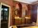 Elegant bathroom with custom vanities, detailed mirrors and lighting, and travertine floors at 9390 Colonnade Trl, Johns Creek, GA 30022