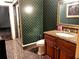 Full bathroom with a granite countertop, wooden vanity, patterned wallpaper, and a glass-enclosed shower at 9390 Colonnade Trl, Johns Creek, GA 30022