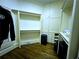 Another view of the walk-in closet, showing ample storage with custom organizers and hardwood floors at 9390 Colonnade Trl, Johns Creek, GA 30022