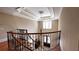 Open foyer featuring a decorative ceiling, chandelier, wood floors, and staircase with iron railing at 9390 Colonnade Trl, Johns Creek, GA 30022