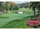 Scenic view of the pristine golf course with a tranquil pond and well-maintained greens at 9390 Colonnade Trl, Johns Creek, GA 30022