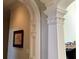 Hallway detail showcasing elegant trim work, arched doorway, and decorative column at 9390 Colonnade Trl, Johns Creek, GA 30022