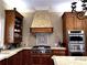 Gourmet kitchen with custom wood cabinets, stainless steel appliances and stone countertops at 9390 Colonnade Trl, Johns Creek, GA 30022