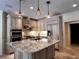 Elegant kitchen with granite island, custom cabinets, stainless appliances, and designer lighting at 9390 Colonnade Trl, Johns Creek, GA 30022