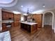 Spacious kitchen with a center island, custom cabinets, stainless steel appliances and dark hardwood floors at 9390 Colonnade Trl, Johns Creek, GA 30022