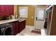 Well-appointed laundry room with modern washer and dryer, cabinet storage, and folding counter at 9390 Colonnade Trl, Johns Creek, GA 30022