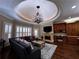 Cozy living room with hardwood floors, fireplace, custom cabinets and tray ceiling at 9390 Colonnade Trl, Johns Creek, GA 30022