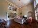 Spacious living room with high ceilings, fireplace, hardwood floors and wrought iron mezzanine at 9390 Colonnade Trl, Johns Creek, GA 30022