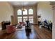 Bright, open living room features soaring ceilings, hardwood floors, fireplace and large windows at 9390 Colonnade Trl, Johns Creek, GA 30022